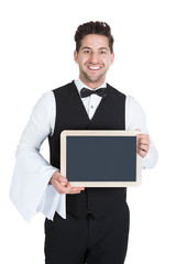 Smiling Young Butler Holding Blank Slate