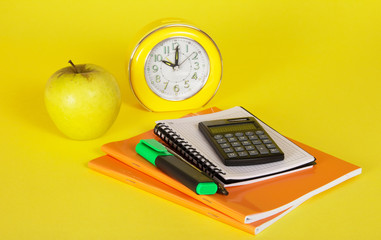 Exercise books, notepad, the calculator and apple