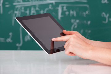 Woman Using Digital Tablet In Classroom
