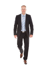 Confident Businessman Walking Over White Background