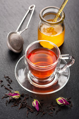 Herbal tea with rose flowers and honey.