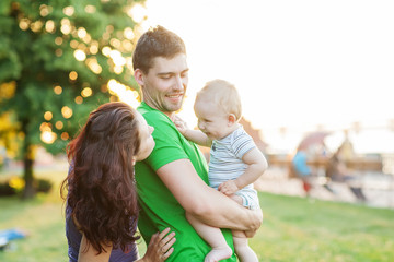 Fototapeta premium Young Attractive Parents and Child Portrait Outdoors