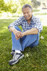 Naklejka na ściany i meble Senior man sitting in park