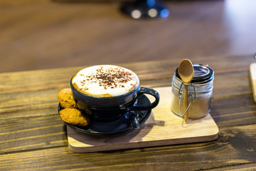 Coffee in cup and cookies in coffee cafe
