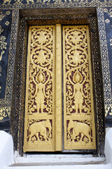 Sculpture and pattern of temple door in Laos