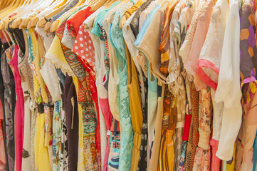 Womens summer clothes hanging on rail