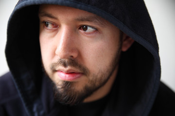 Young man in dark hoodie