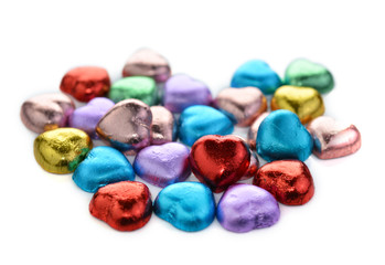 Fototapeta na wymiar Heart shaped chocolates cover white color foil
