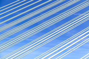 pattern of steel wires of a bridge under blue sky