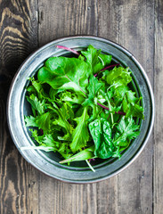 Green salad on rustic background