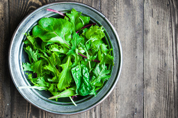 Green salad on rustic background