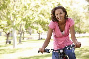 Fototapeta premium Young woman cycling in park