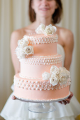 Wedding cake in bride's hands