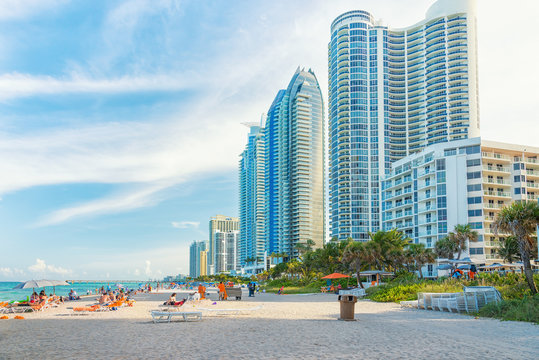 Tourists And Locals Enjoying The Beach At Miam