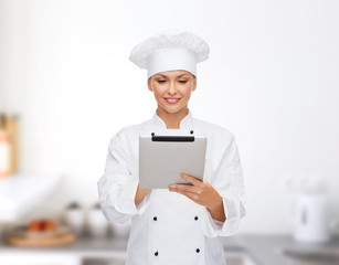 smiling female chef with tablet pc computer