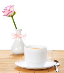 Fototapeta na wymiar Rose in vase with bow and tea-things