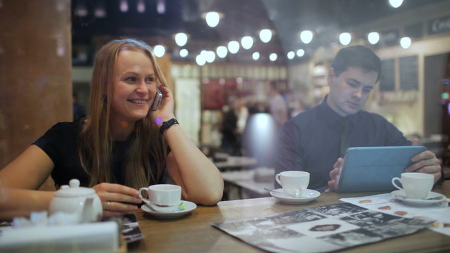 Young people in a cafe with phone and Tablet PC