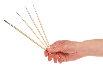 Brushes in a hand of the artist
