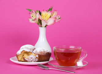 Cup with tea and cupcakes
