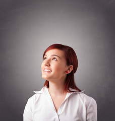 Fototapeta premium Young woman standing and thinking with copy space