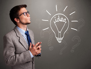 Young boy comming up with a light bulb idea sign