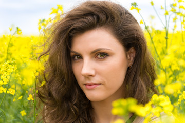woman portrait in yellow flower field