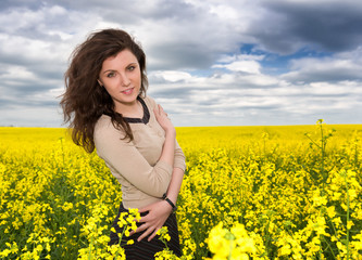 Naklejka na ściany i meble girl portrait in yellow flower field