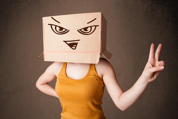 Young woman gesturing with a cardboard box on her head with evil