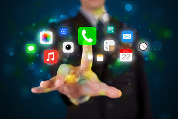 Handsome businessman pressing colorful mobile app icons with bok