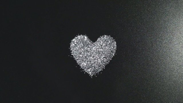 Silver glitter arrange to heart shape with flying light