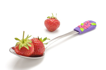 Organic strawberries in the spoon isolated