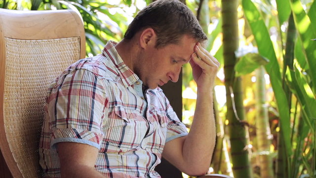 Worried man sitting in the garden