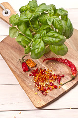 fresh basil on wooden chopping board 