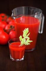 Tomato celery juice in a glass on the table, selective focus