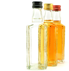 glass bottles filled with liquids of different colors