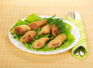Pancakes with salmon and salad, cutlery