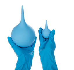 Hands in the gloves, holding pears for an enema