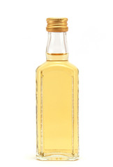 a glass bottle filled with liquid yellow in color