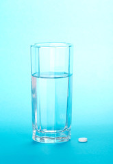 Glass with water and tablets