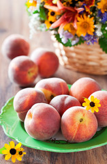 Fresh ripe peaches on a plate, selective focus