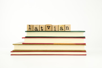 latvian language word on wood stamps and books