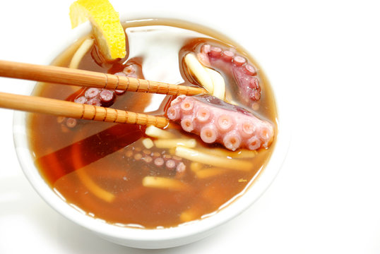 Eating Noodle and Octopus Soup with Chopsticks