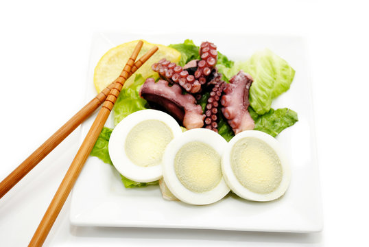 Eating Egg and Octopus Salad with Chopsticks