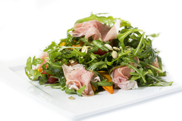 salad of arugula ham cheese on a white background