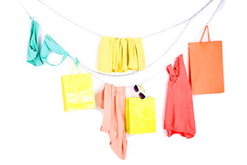 color clothes and shopping bags on white