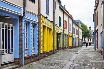 Narrow street with a small colorful houses in Amiens, France