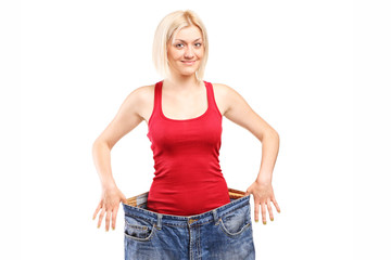 Fototapeta premium Woman standing in a pair of oversized jeans