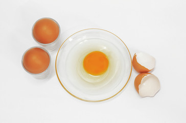 Broken eggs on white background
