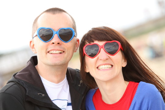 Woman and man with glasses shaped heart, summer time