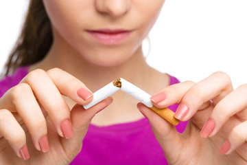 Young woman is breaking a cigarette